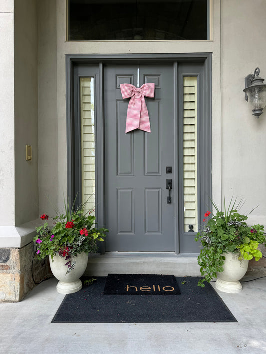 Pink front door bow on grey front door