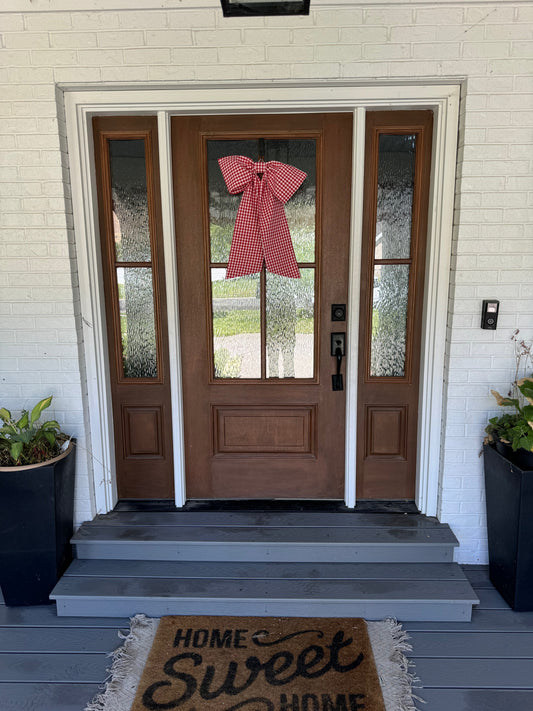 Red gingham bow hanging from door
