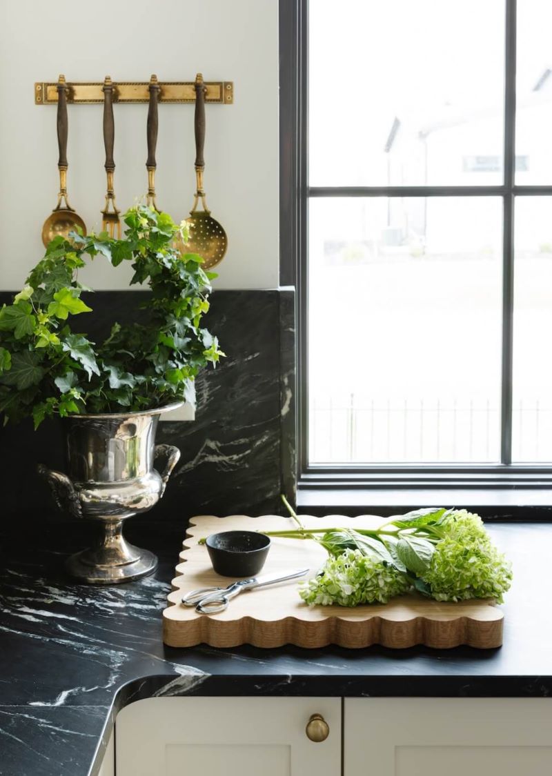 Oak cutting board on dark countertop