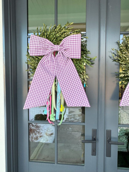 Purple Gingham Bow with spring colored ribbons, hanging from a wreath set on a front door