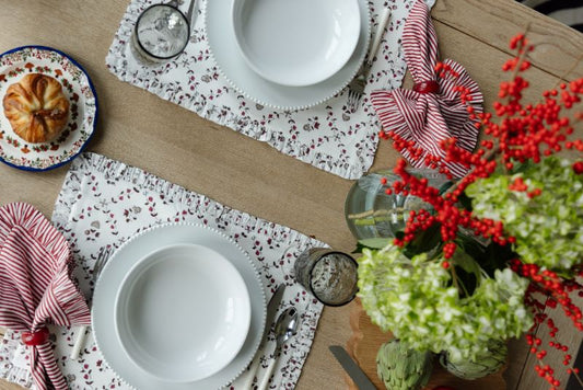 red floral ruffled placemats on table with white plates