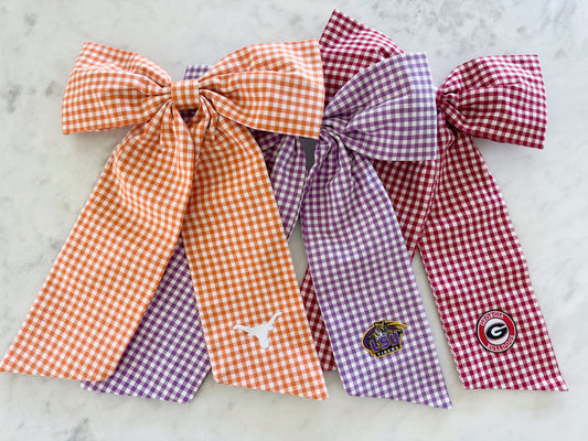 Orange, purple, and red gingham bow with college patches ironed on
