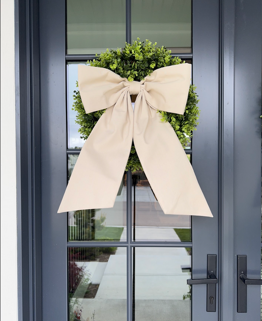 Solid Cream Linen Bow hanging from wreath on front foor