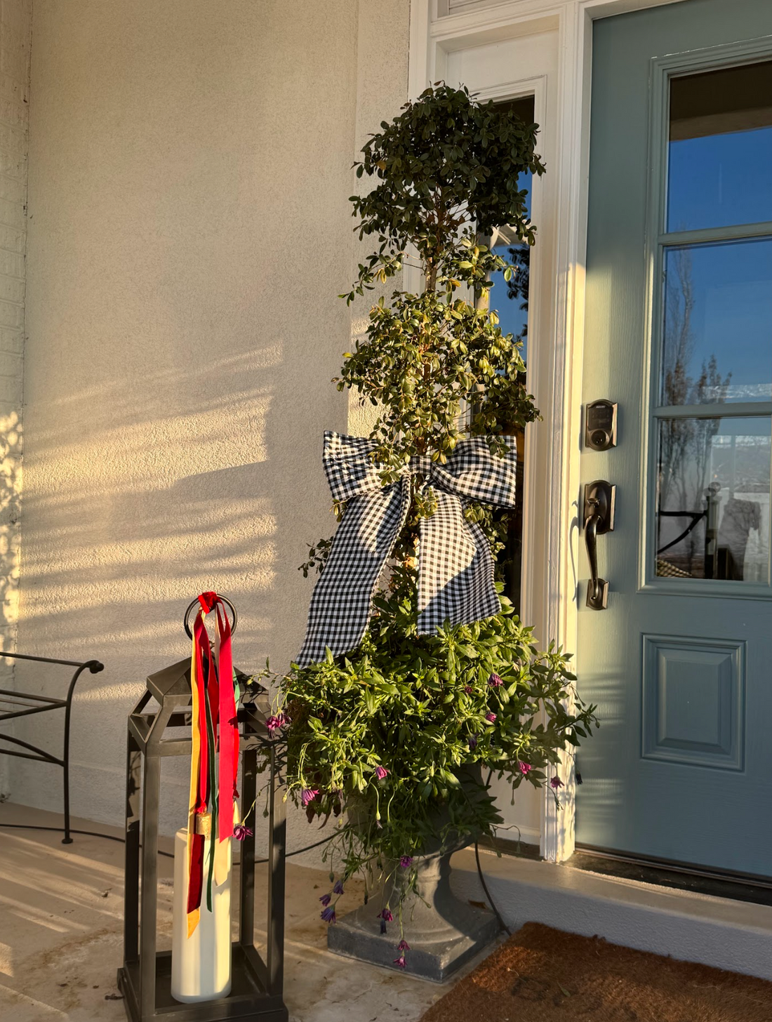Black Gingham bow hanging from tree by front door 